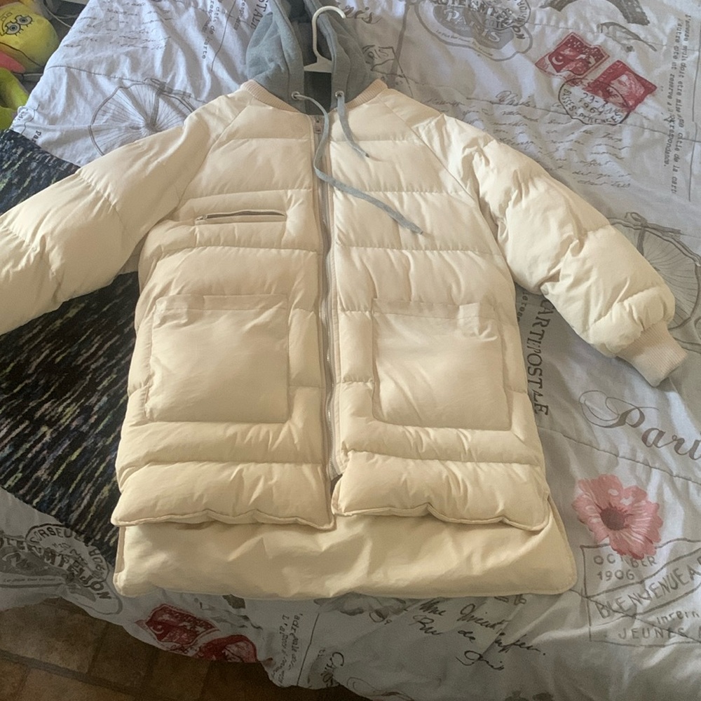 White winter coat with a grey hood and strings
